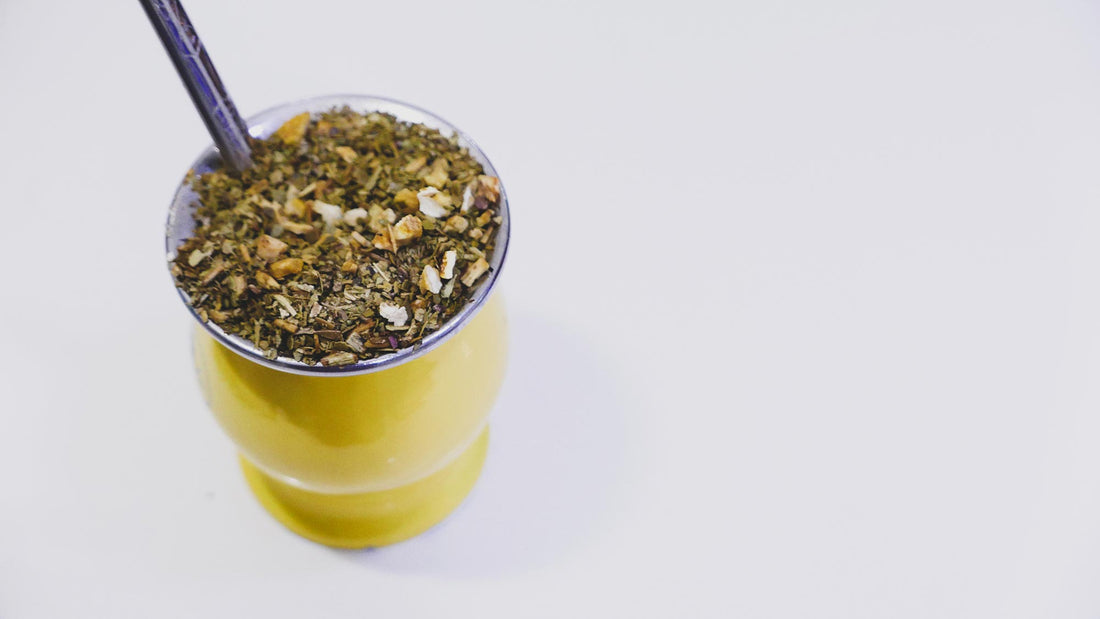 Yerba mate tea in yellow metal gourd