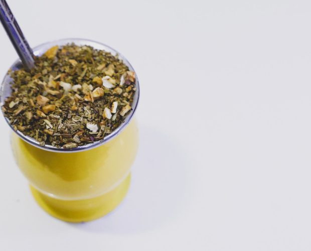 Yerba mate tea in yellow metal gourd